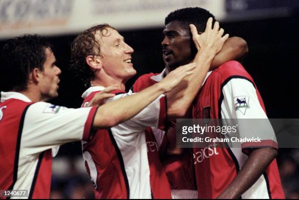 Marc Overmars and Ray Parlour congratulate Arsenal team mate Kwankwo Kanu on his second and equalising goal during the FA Carling Premier League...