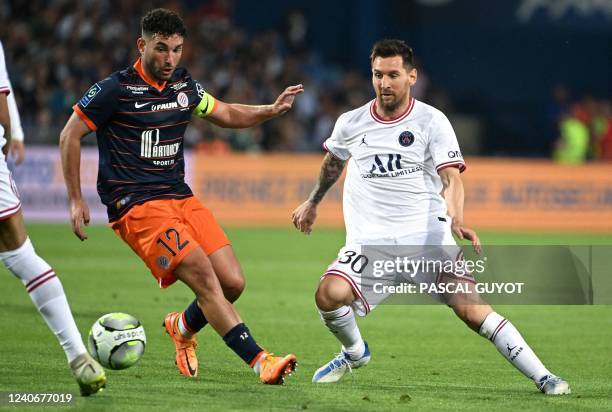 Montpellier's French midfielder Jordan Ferri fights for the ball with Paris Saint-Germain's Argentinian forward Lionel Messi during the French L1...