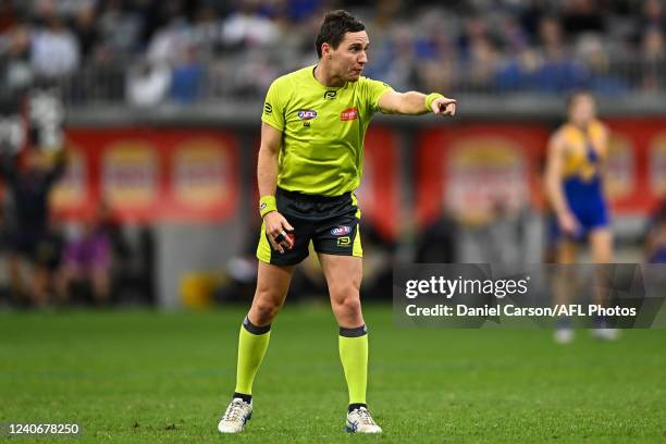 The umpire makes a call during the 2022 AFL Round 09 match between the West Coast Eagles and the Melbourne Demons at Optus Stadium on May 15, 2022 in...