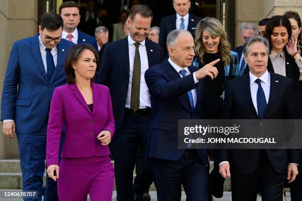 Deputy Secretary General Mircea Geoana gestures as with German Foreign Minister Annalena Baerbock and US Secretary of State Antony Blinken they walk...