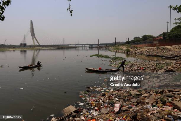 Fisherman rows his boat in the polluted waters of Yamuna River ahead of the 'World Climate Change Day', in New Delhi, India on May 14, 2022.