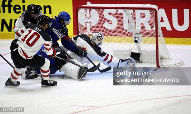 Italy's forward Marco Sanna tries to score against Canada's goalkeeper Christopher Driedger during the 2022 IIHF Ice Hockey World Championships...