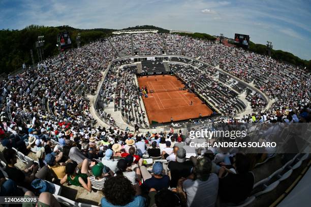 General view shows spectators watching the final of the Women's WTA Rome Open tennis tournament between Poland's Iga Swiatek and Tunisia's Ons Jabeur...
