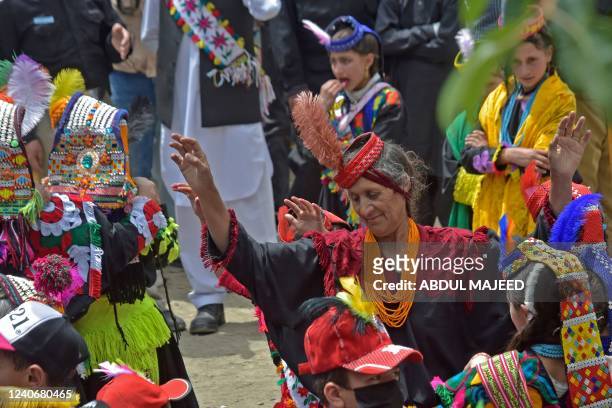 Kalash tribe women wearing traditional dresses arrive to take part in the 'Chilam Joshi' festival celebrating the arrival of spring at Bumburet...