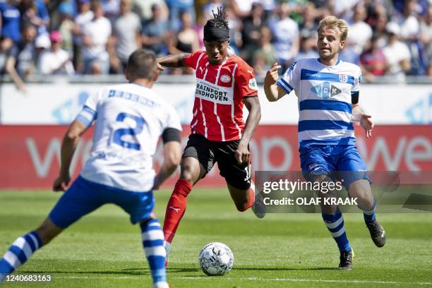 S English forward Noni Madueke is challenged by Zwolle's Dutch midfielder Thomas van den Belt during the Dutch Eredivisie football match between PEC...