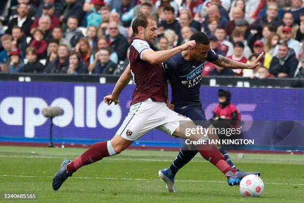 Manchester City's Brazilian striker Gabriel Jesus is tackled by West Ham United's English defender Craig Dawson during the English Premier League...