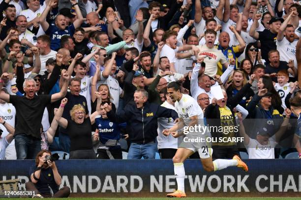 Leeds United's Dutch defender Pascal Struijk celebrates in front of fans after scoring their late equalizer during the English Premier League...