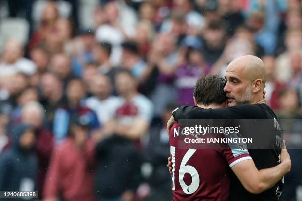 Manchester City's Spanish manager Pep Guardiola embraces West Ham United's English midfielder Mark Noble at the end of the English Premier League...