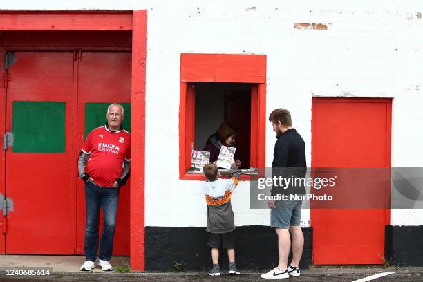 Swindon Town supporters collect a programme ahead of the Sky Bet League 2 Play-Off Semi-Final 1st Leg between Swindon Town and Port Vale at the...