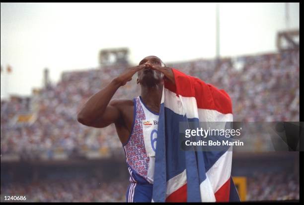 LINFORD CHRISTIE OF GREAT BRITAIN BLOWS KISSES TO THE CROWD AFTER CLAIMING VICTORY IN THE MENS 100 METRE SPRINT FINAL AT THE 1992 BARCELONA OLYMPICS....