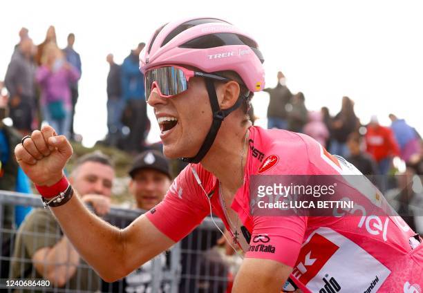 Team Trek's Spanish rider Juan Pedro Lopez celebrates keeping the overall leader's pink jersey as he crosses the finish line after the 9th stage of...