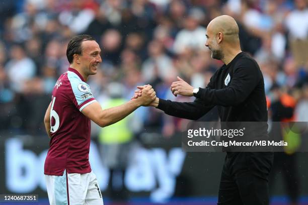 Manchester City manager Pep Guardiola embraces Mark Noble of West Ham United after the Premier League match between West Ham United and Manchester...