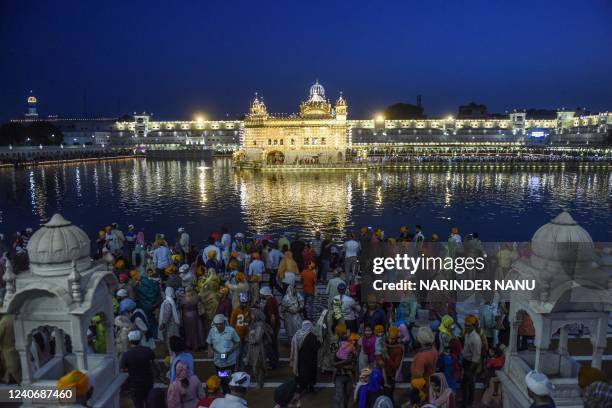 Sikh devotees pay respect on the occasion of birth anniversary of Guru Amar Das Ji, the third guru of Sikhs, at the illuminated Golden temple in...