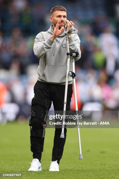 An injured Stuart Dallas of Leeds United applauds the fans at full time during the Premier League match between Leeds United and Brighton & Hove...