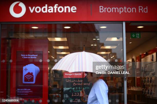 Pedestrian passes a Vodafone store in west London on May 15, 2022.