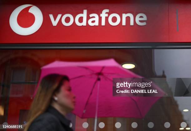 Pedestrian passes a Vodafone store in west London on May 15, 2022.