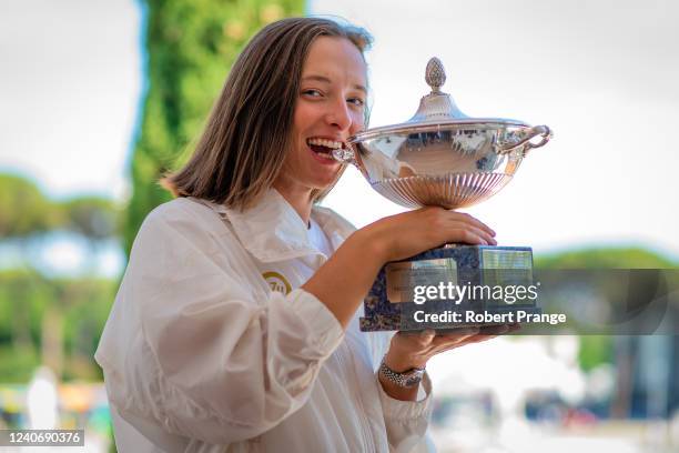 Iga Swiatek of Poland poses with the champions trophy after defeating Ons Jabeur of Tunisia in the womens single final during Day 8 of the...