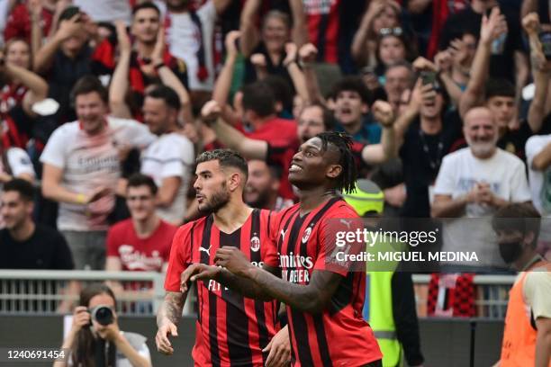 Milan's French defender Theo Hernandez celebrates AC Milan's Portuguese forward Rafael Leao's goal during the Italian Serie A football match between...