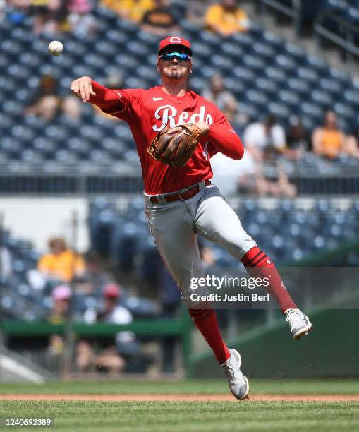 Matt Reynolds of the Cincinnati Reds throws to first base to force out Ke'Bryan Hayes of the Pittsburgh Pirates in the fourth inning during the game...