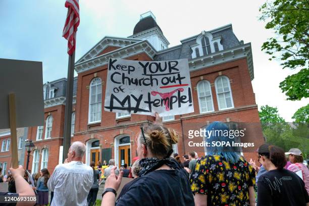 Demonstrator holds a placard reading "Keep Your Church Out of My Temple " during the abortion rights rally in Milford. At least two hundred people...