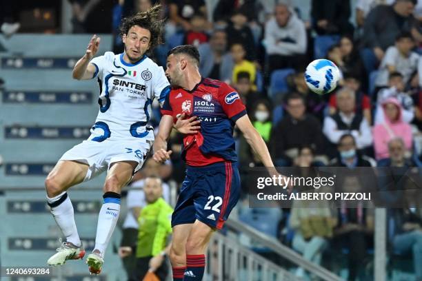 Inter Milan's Italian defender Matteo Darmian and Cagliari's Greek defender Charis Lykogiannis go for a header during the Italian Serie A football...