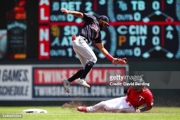 Luis Arraez of the Minnesota Twins steals second base against Amed Rosario of the Cleveland Guardians in the first inning of the game at Target Field...