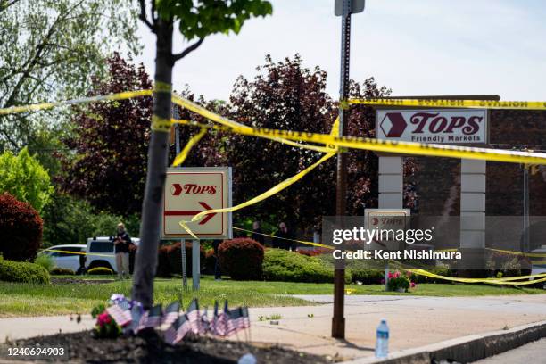 People gather outside the police tape at Tops Friendly Market at Jefferson Avenue and Riley Street on Sunday, May 15, 2022 in Buffalo, NY. The fatal...