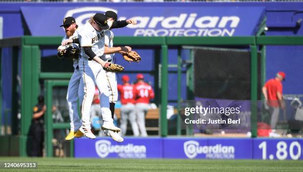 Ben Gamel of the Pittsburgh Pirates celebrates with Bryan Reynolds and Jack Suwinski after the final out in a 1-0 win over the Cincinnati Reds at PNC...