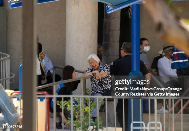 Laguna Woods, CA A counselor attends to a grieving woman, center, outside the Geneva Presbyterian Church in Laguna Woods on Sunday, May 15, 2022...