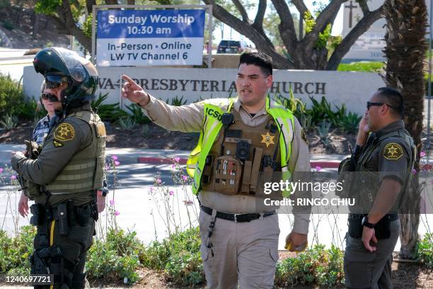 Police investigate after a shooting inside Geneva Presbyterian Church in Laguna Woods, California, on May 15, 2022. - One person was dead and four...