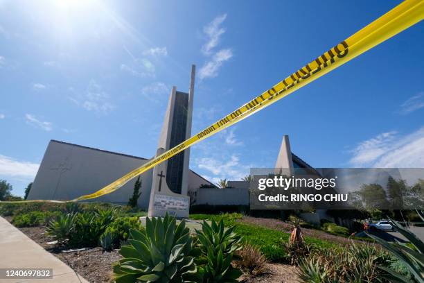 Police yellow tape is seen after a shooting inside Geneva Presbyterian Church in Laguna Woods, California, on May 15, 2022. - One person was dead and...