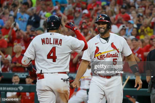 Yadier Molina of the St. Louis Cardinals is congratulated by Albert Pujols after Molina hit a two-run home run during the fifth inning against the...