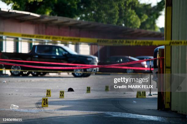 The scene of a shooting is pictured behind police yellow tape after two people were killed and three more critically injured in a shooting at a flea...