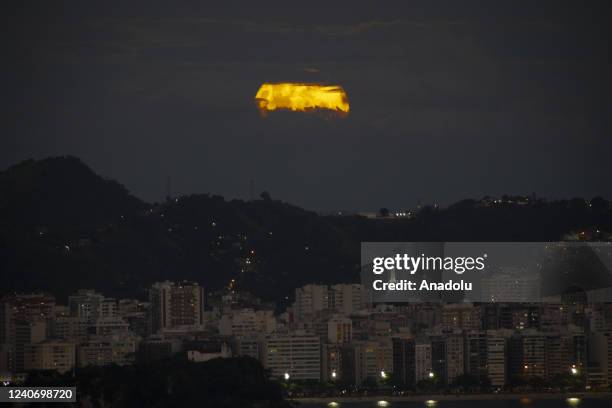 Blood Moon, a full moon that coincides with a full lunar eclipse and that has a reddish appearance, rises over the city of Rio de Janeiro, Brazil on...