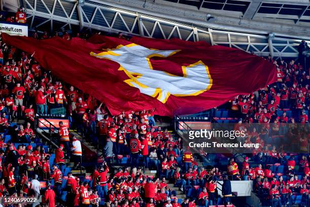 The crowd passes along a flag before the game between the Calgary Flames and Dallas Stars in Game Seven of the First Round of the 2022 Stanley Cup...