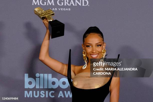 Rapper Doja Cat poses in the press room with her awards during the 2022 Billboard Music Awards at the MGM Grand Garden Arena in Las Vegas, Nevada,...