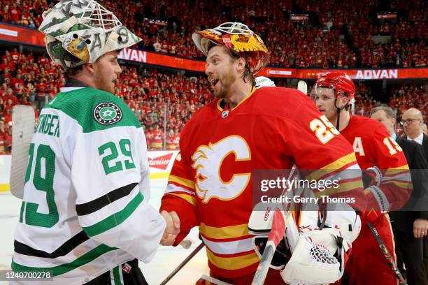 Jacob Markstrom of the Calgary Flames shakes hands with Jake Oettinger after a series win against the Dallas Stars in Game Seven of the First Round...