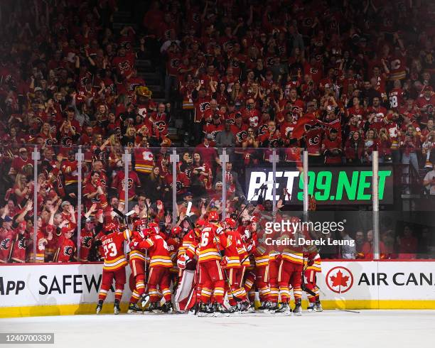 The Calgary Flames celebrate after defeating the Dallas Stars during the overtime period of Game Seven of the First Round of the 2022 Stanley Cup...