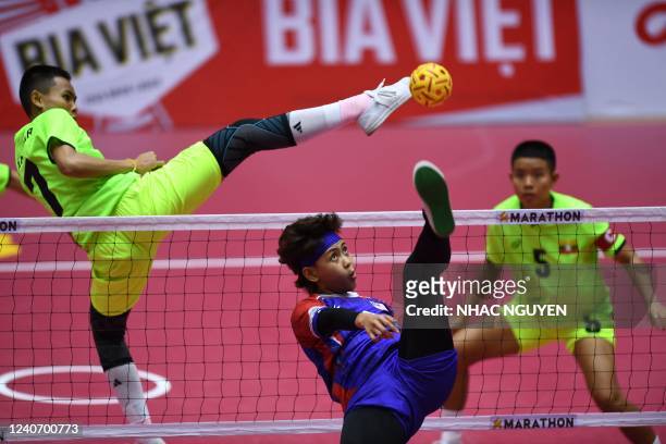 Myanmar's Ya Mone Zin kicks a shot in the sepaktakraw match against Malaysia during the 31st Southeast Asian Games in Hanoi on May 16, 2022.