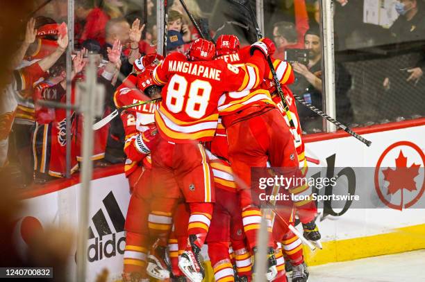 Calgary Flames Left Wing Johnny Gaudreau is mobbed by teammates after scoring the series winning goal during the first overtime period of game 7 of...