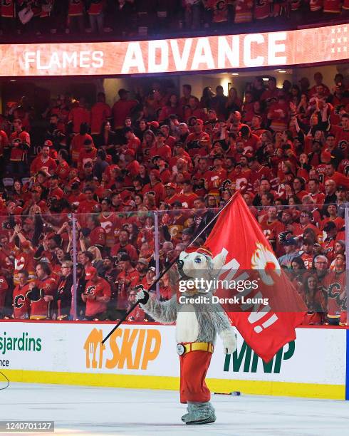 The Calgary Flames' Mascot, Harvey The Hound, waves a flag after the Flames defeated the Dallas Stars in overtime during Game Seven of the First...