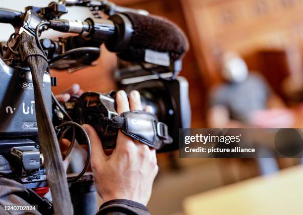 May 2022, Schleswig-Holstein, Flensburg: A cameraman films the 34-year-old defendant in the opening trial for murder. On Nov. 20 the defendant...