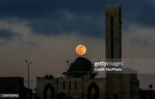 The super flower blood moon appears over Gaza City, May 15, 2022.