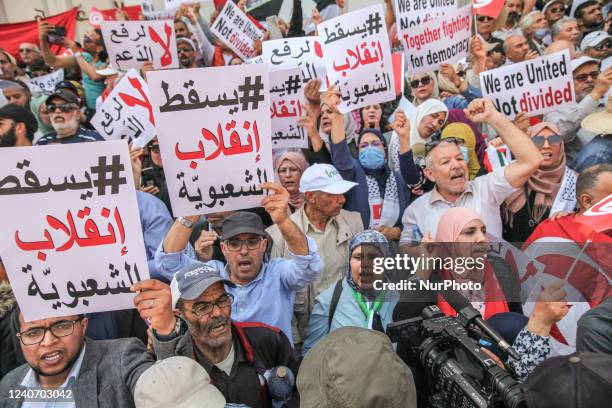 Protestors chant slogans as they raise placards that read, down with the coup of populism during a demonstration held by supporters of the movement...