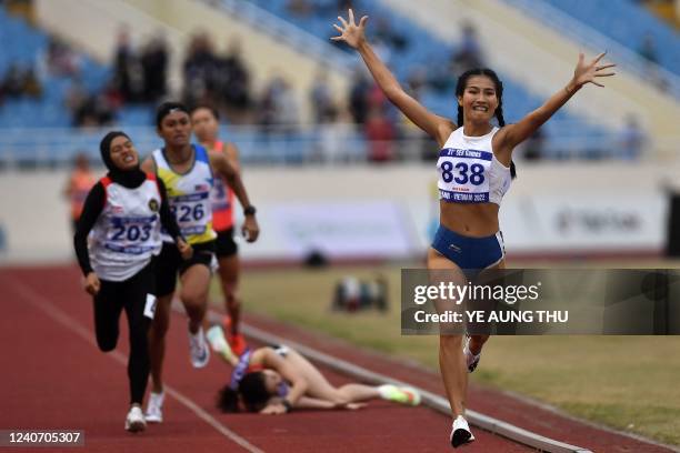 Vietnam's Khuat Phuong Anh celebrates winning the women's 800m final during the 31st Southeast Asian Games at My Dinh National Stadium in Hanoi on...