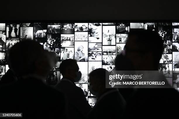 People stand in front of the screen with pictures from Intesa Sanpaolo Publifoto Archive at the Gallerie dItalia Torino museum, in the northern city...