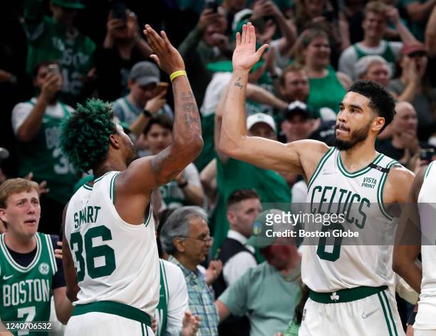 The Celtics Marcus Smart and Jayson Tatum high five as the starters leave the game with the outcome not in doubt. The Boston Celtics host the...