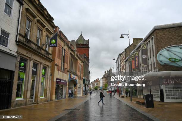 Pedestrians pass through a central square in the market town of Darlington, UK, on Friday, May 6, 2022. Darlington has emerged as the poster child...