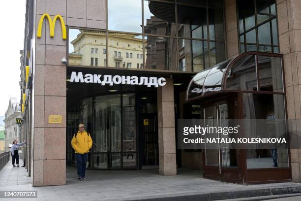 Man walks past a closed McDonald's restaurant in Moscow on May 16, 2022. - American fast-food giant McDonald's will exit the Russian market and sell...