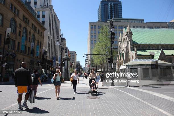 Pedestrians cross a street after the province of Quebec lifted its mask mandate in Montreal, Quebec, Canada, on Saturday, May 14, 2022. Quebec's...